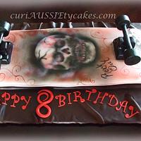 Skull and guitar skateboard cake
