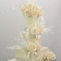 White Wedding Cake With Sugar Flowers and Wafer Paper Fethers