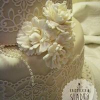 White wedding cake with hearts on the top