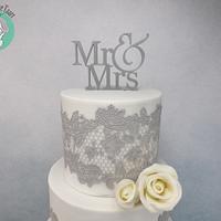 Wedding cake with gray cake lace and modeling chocolate roses