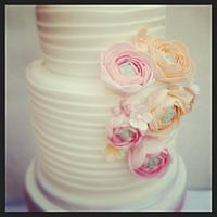 White wedding cake with Ranunculus flowers