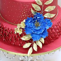 Red & Gold Wedding Cake with Royal Blue Flowers