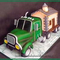 Kenworth Truck and trailer carrying a house Cake