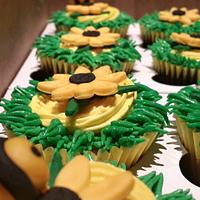 Sunflower cupcakes with a few bee invaders