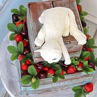 Wooden box with strawberries and cat