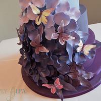 Falling petals wedding cake with butterflies