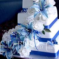 Blue lilies and white rose wedding cake