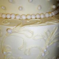 white sparkly buttercream wedding cake with lace piping