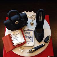 Birthday cake with Mulberry bag Chanel shoe pearl earrings and necklace and an agenda