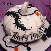 White pumpkin and creepy crawlers Halloween cake