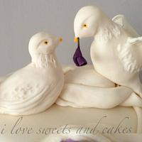 Beautiful drapes, doves and roses wedding cake