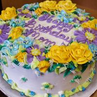Happy buttercream flowers on layer cake