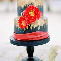 Wedding cake in black, gold and red.