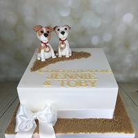 Two dogs  in the sand engagement  cake 