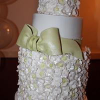 A 5 tier wedding cake (3 foot high) decorated with 800 sugar flowers and bows