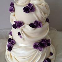 Beautiful drapes, doves and roses wedding cake