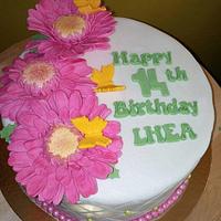 Pastel colored themed cake with gerber daisy