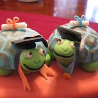 Graduation Turtles atop a stack of Books