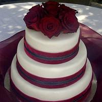 Elegant but simple wedding cake with red roses