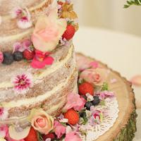 "Naked' cake with bunting and edible flowers