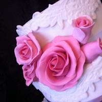 white, lace and roses wedding cake