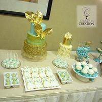 Gold and seafoam green wedding cake and dessert table