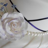 Purple ribbon and pearl wedding cake