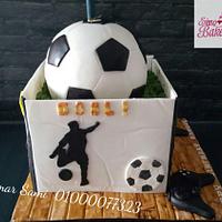Soccer ball and playstation box cake .