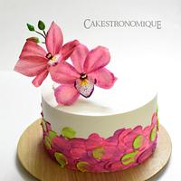 Edible wafer paper Cymbidium Orchid adorned whipped cream frosted cake