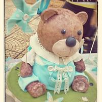 Teddy bear holds a Pinwheel Cake