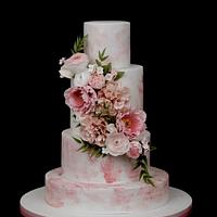 Pink watercolor effect cake with sugarflowers