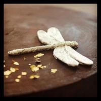 Minimalist ganache cake with silver-plated dragonfly and gold flakes