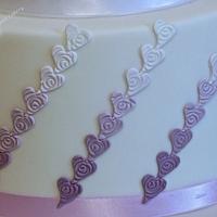 Purple roses and hearts wedding cake