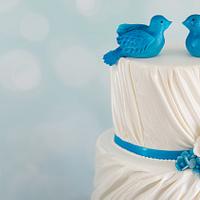 Bluebirds and roses wedding cake