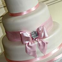Simple cake with edible bow and brooch