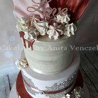 Rose gold wedding cake with lace and ruffles