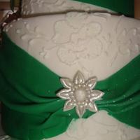 emarald green wedding cake adorned with roses