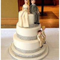 3 tier wedding cake with diamante trim and edible bride, groom and their 2 boys