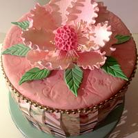 Pleaded prints wafer paper cake with a gumpaste peony.