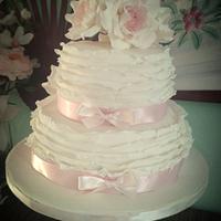 ivory frills and roses wedding cake with a hint of pink