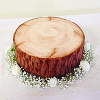 Semi naked wedding cake with edible log stand 