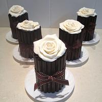 Decorating with dark chocolate cigarillos and white chocolate roses