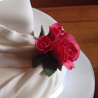 Drapes and roses wedding cake
