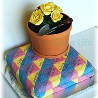 folded quilt and flower pot
