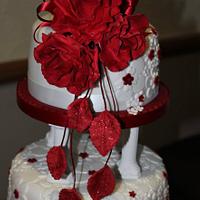 Embossed wedding cake with red rose topper