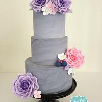 Grey marbled wedding cake with sugar roses