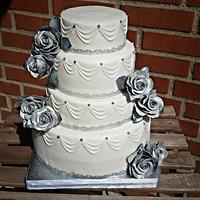 White wedding cake with silver roses