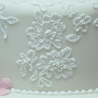 Customised piped lace wedding cake taken directly from wedding dress