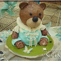 Teddy bear holds a Pinwheel Cake