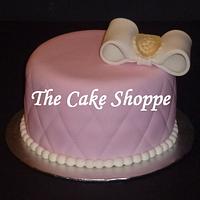 pink cake with white bow